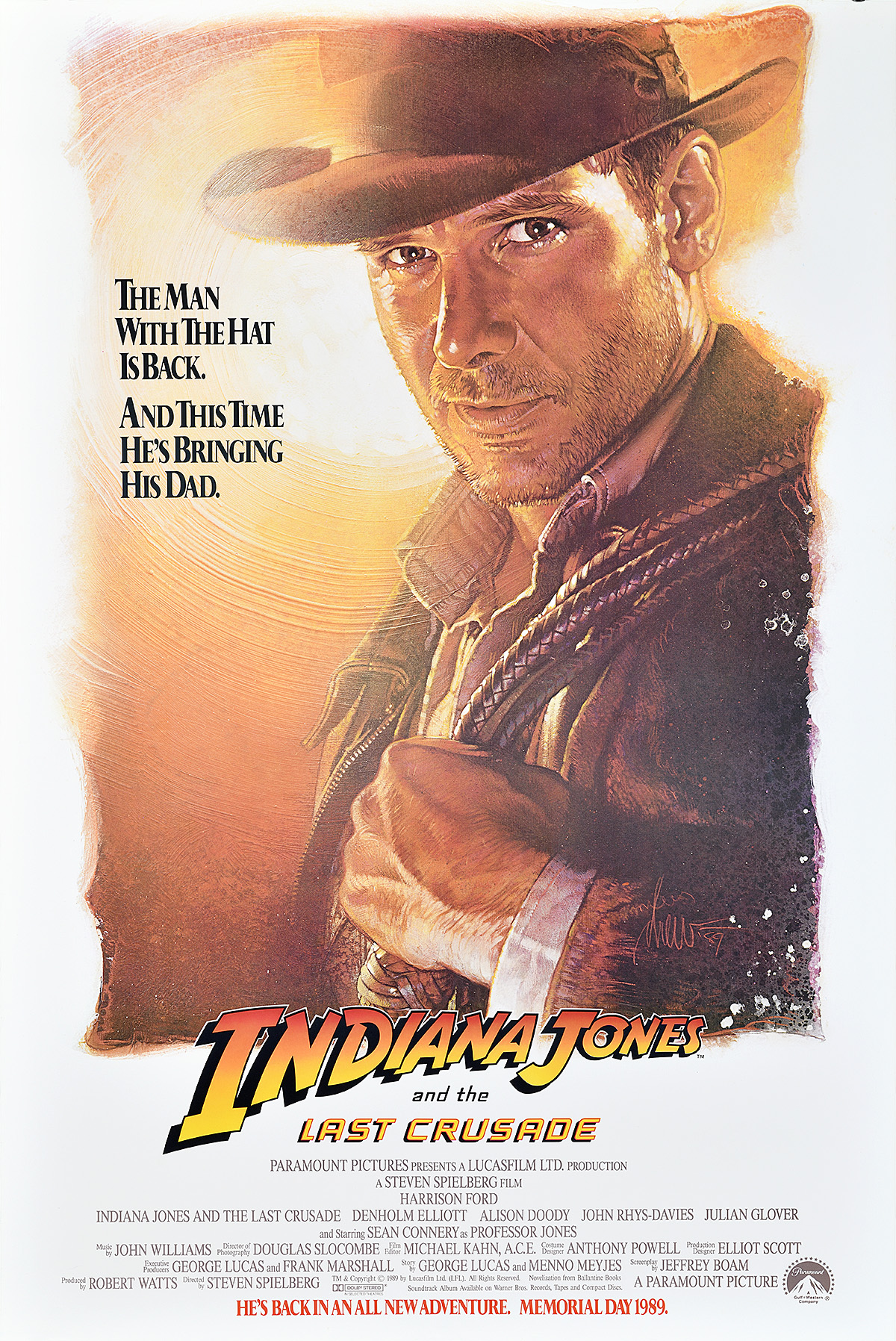 A poster of a man looking earnestly at the viewer wearing a cowboy hat and holding a whip.