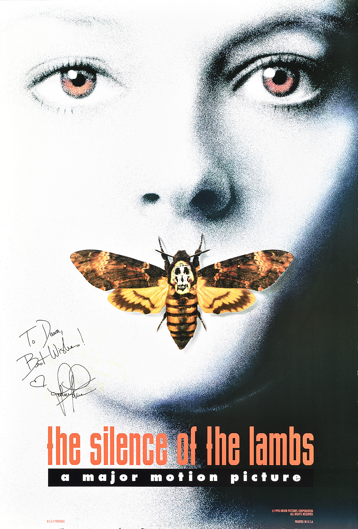 A signed poster of an overexposed white woman's face with orange eyes and a moth over her mouth.