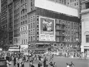 An image of a city with an advertisement on a building with hands shaking.