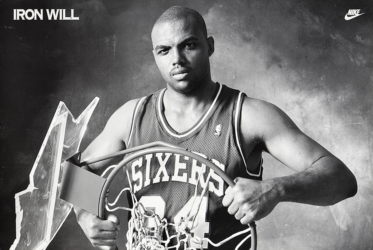 A black-and-white poster of a Black man in a basketball tank top holding a shattered basketball hoop.