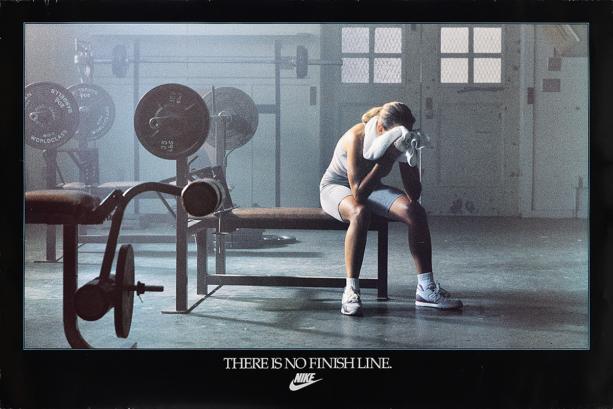 A poster of a woman sitting on a workout bench in a gym as she wipes sweat off her face with a towel.