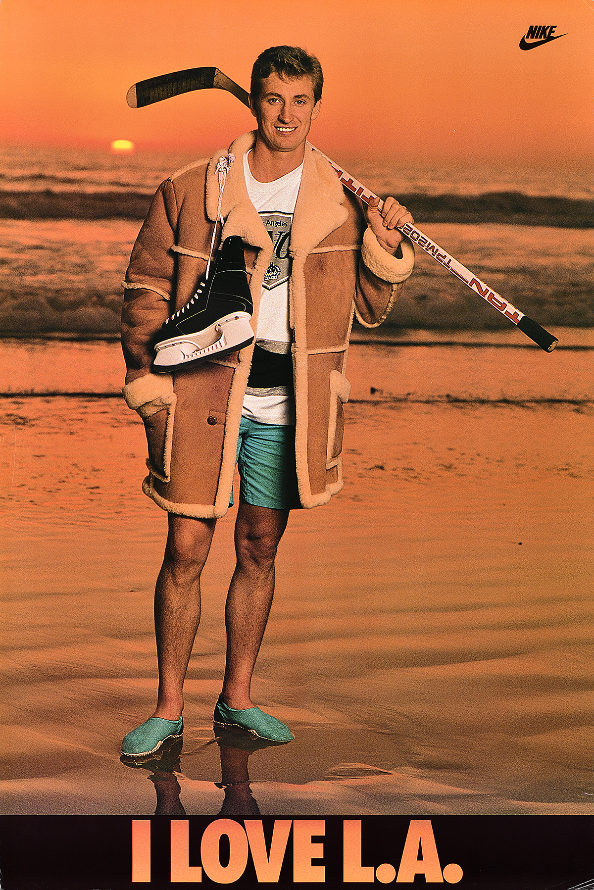 A poster of a white man in shorts and a jacket standing at the shore with a hockey stick and skates.