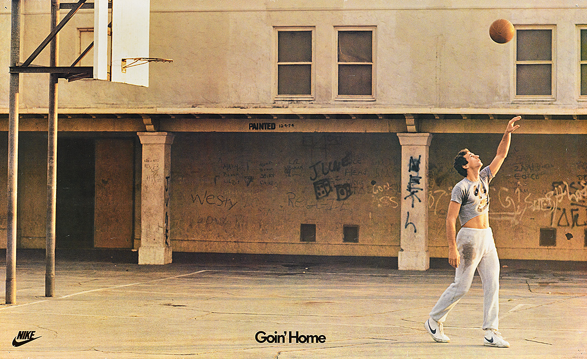 A poster of a white man in casual clothes playing basketball on an indoor court covered in graffiti.