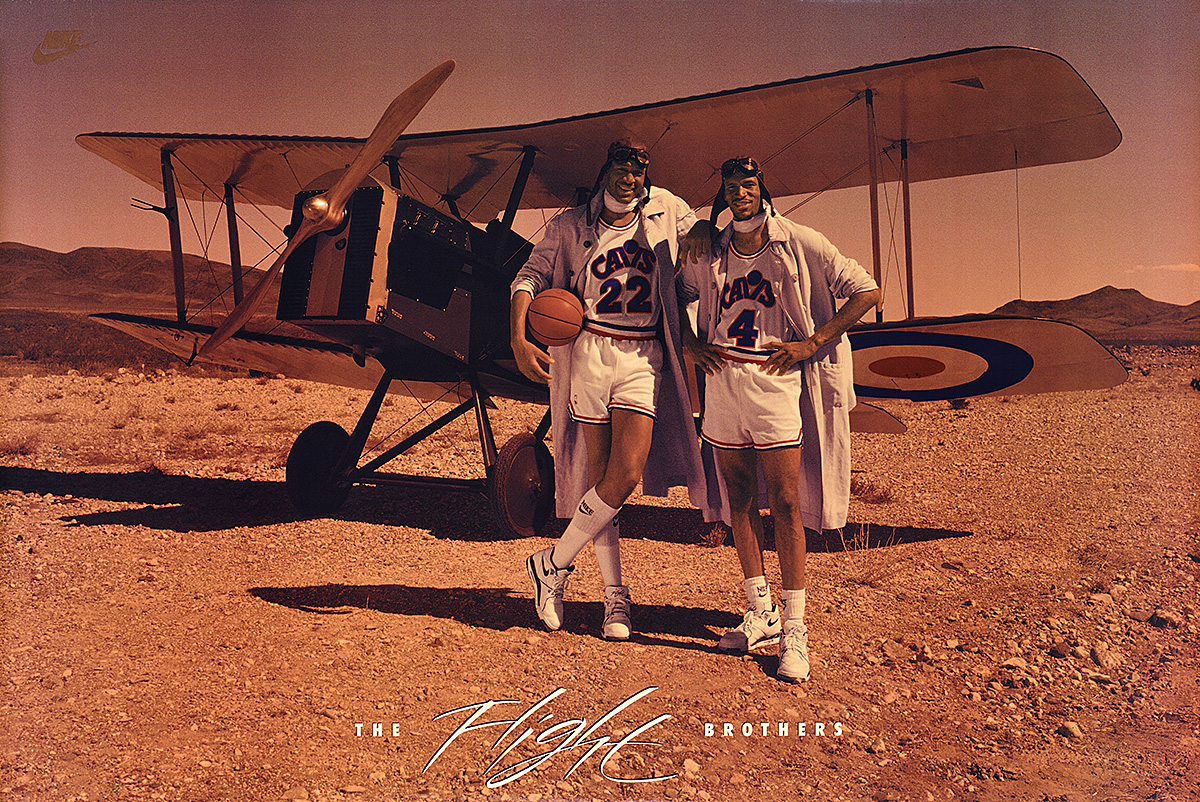 A poster of two Black male basketball players in goggles and flight helmets, posing before a vintage biplane.