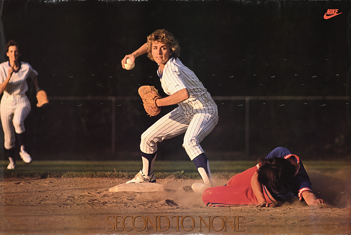 A poster of a white woman in uniform throwing a softball as another woman slides toward a base.