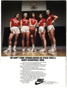 A magazine advertisement of 5 female basketball players looking down at the viewer. 