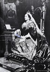 A poster of a white woman in a crown and royal dress sitting looking ominously to the right