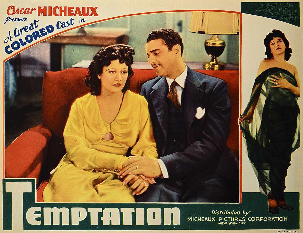 A poster of a man and woman sitting on a couch holding hands while the man looks adoringly at her.
