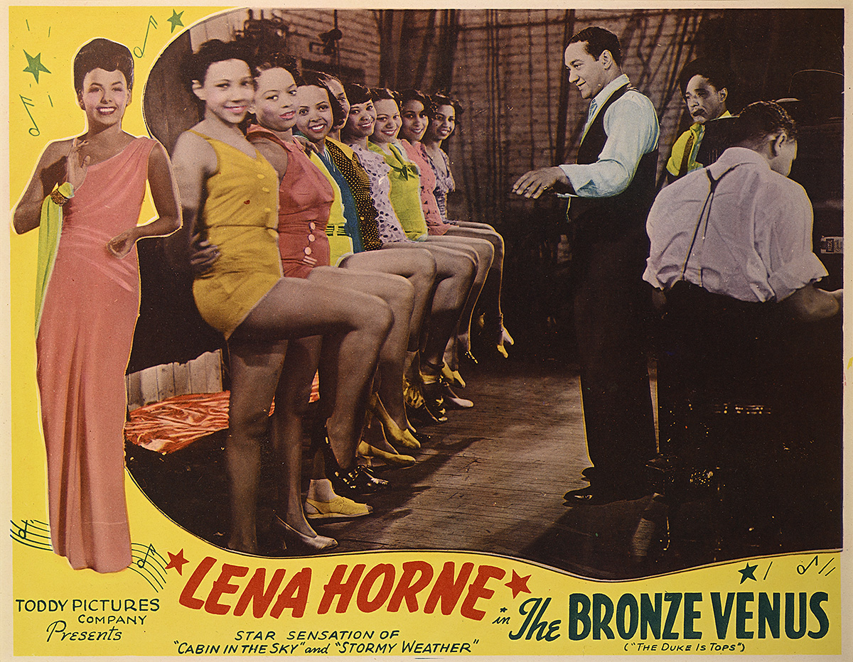 A poster with dancing girls in colorful outfits.