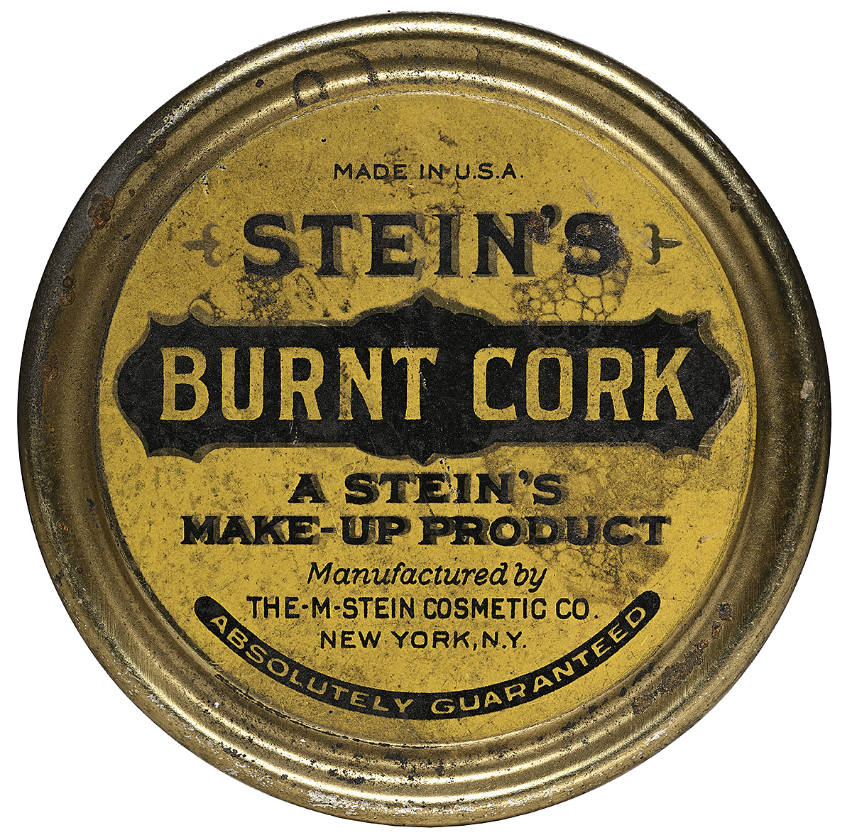 The top of a yellow circular tin with black text.