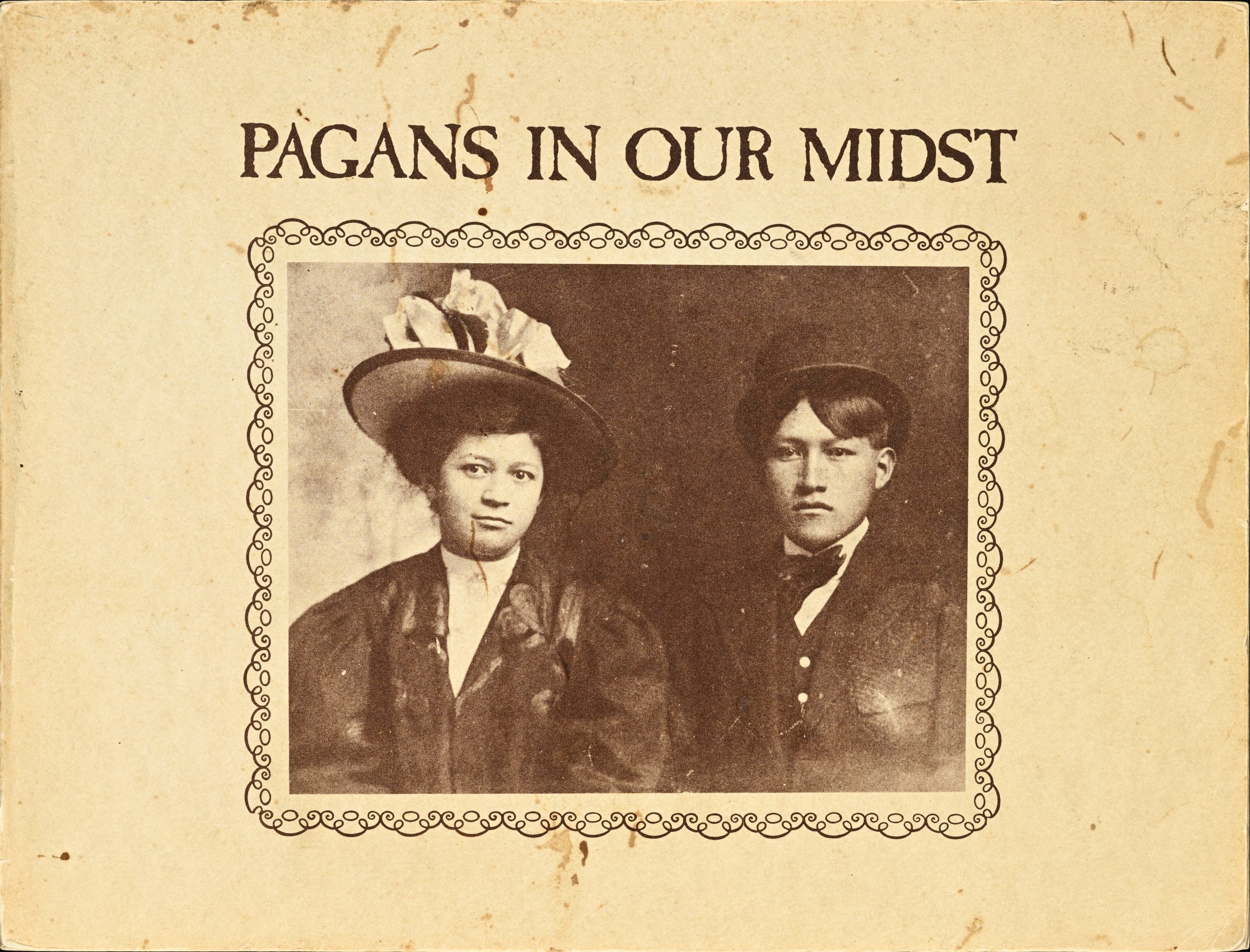 A photograph of a man and woman in fancy clothes with a decorative border on aged paper.