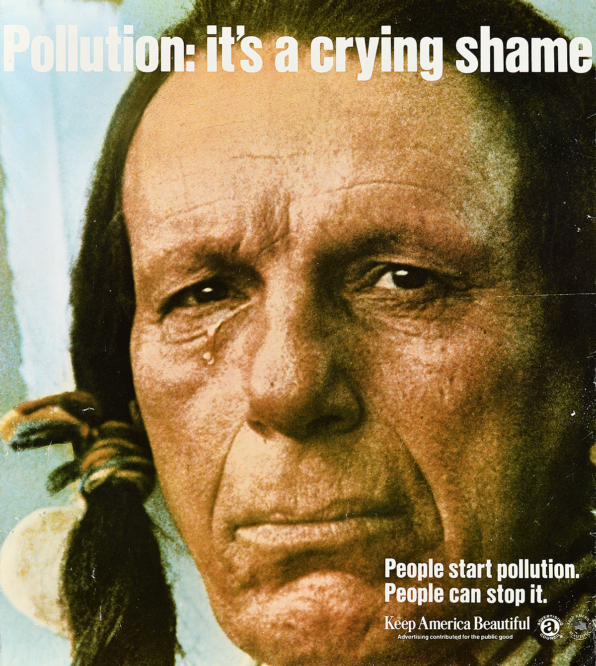 A poster with a photograph of an Indigenous person with one tear falling and looking at the viewer.