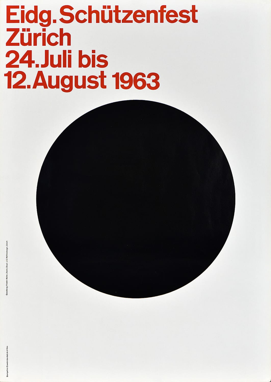 A poster with a large black circle in the center and red text in the upper left corner.